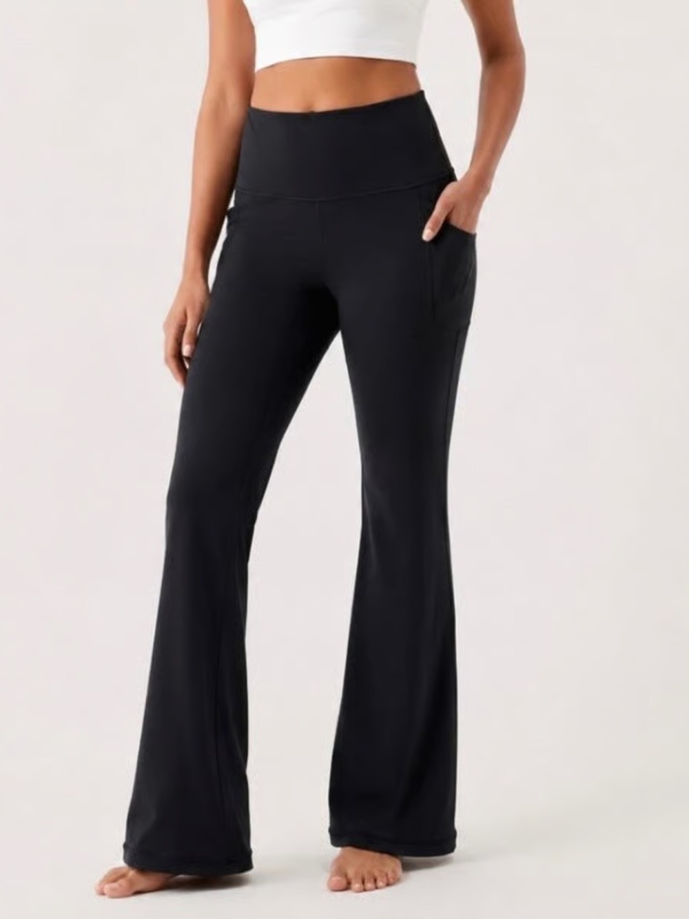 Athleta Salutation Stash Flare Pant In Black size medium Athlesiure Yoga Casual